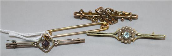 Three bar brooches including 9ct gold and a 9ct gold safety pin.